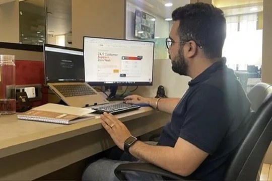 Vicky Lalwani checking website tracking and reporting at his desk